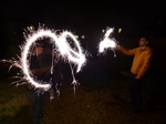 FZ024579 Jenni and Phill setting of sparklers in the garden.jpg